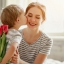 A boy giving his mother flowers and wishing all the best on Mothers Day